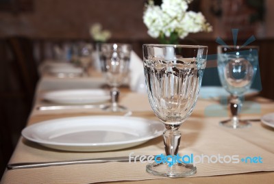 Glasses And Plates On Table Stock Photo