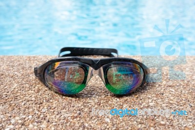 Glasses For Swimming On A Cement Floor With Small Stone Near Swi… Stock Photo