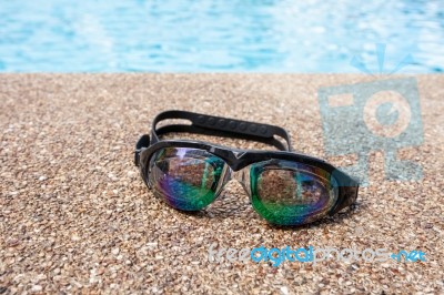 Glasses For Swimming On A Cement Floor With Small Stone Near Swi… Stock Photo