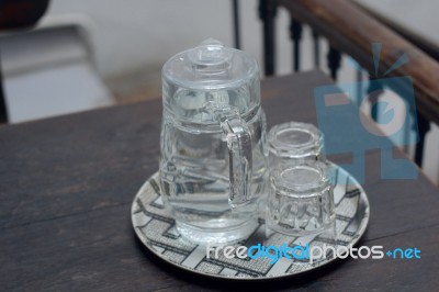 Glasses Of Water Are Placed On A Plate At The Wooden Table Stock Photo Glasses Of Water Are Placed On A Plate At The Wooden Table Stock Photo