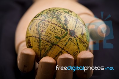 Global In Wooden Hand Stock Photo