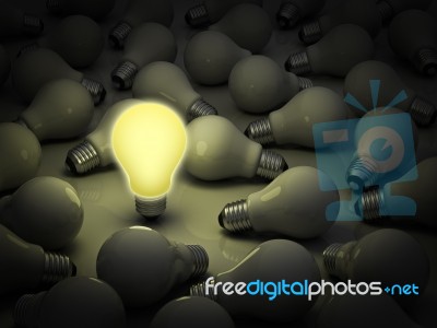 Glowing Light Bulb Out Of Unlit Stock Image
