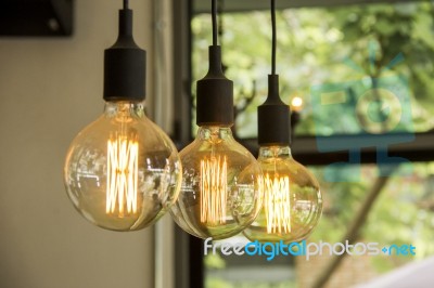 Glowing Retro Light Bulbs Hanging From Ceiling Stock Photo