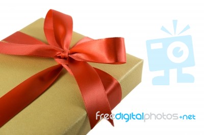Gold Gift Box With Red Ribbon Bow, Isolated On White Background Stock Photo