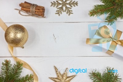 Golden Christmas Decoration On White Wood Background Stock Photo