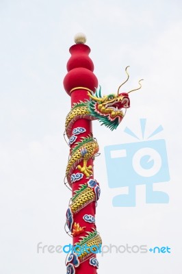Golden Dragon Statue On Pole In The Chinese Temple In Thailand Stock Photo