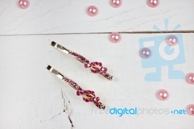 Golden Hairpins With Pink Gemstone And Pink Pearls On White Wood… Stock Photo