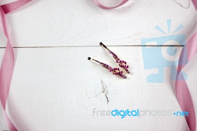 Golden Hairpins With Pink Gemstone And Pink Ribbon On White Wood… Stock Photo