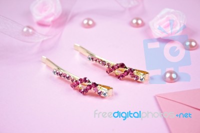Golden Hairpins With Pink Gemstone On Pink Background Stock Photo