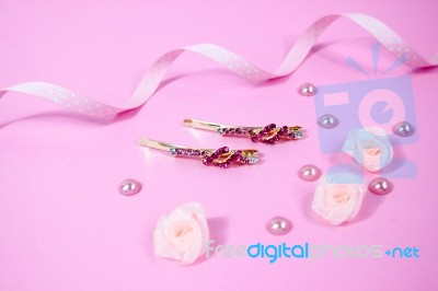 Golden Hairpins With Pink Gemstone On Pink Background Stock Photo