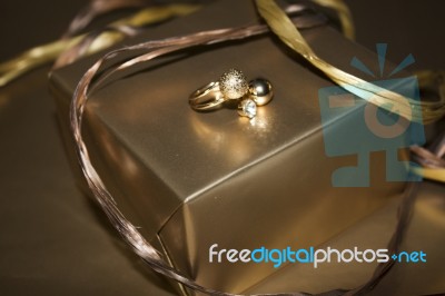 Golden Ring With Golde Ngift And Decoration On Golden Background… Stock Photo