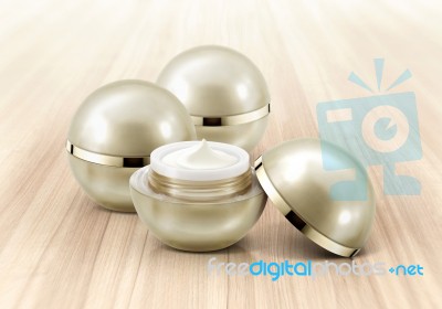 Golden Sphere Cosmetic Jar On Wood Background Stock Photo