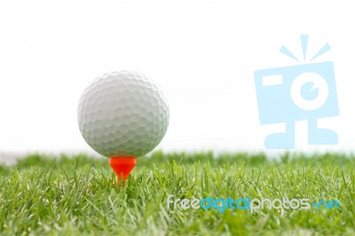 Golf Ball On Plastic Tee In Green Grass Stock Photo