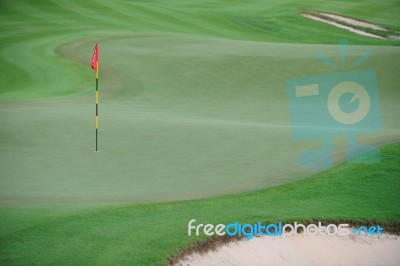 Golf Green With Red Flag Stock Photo