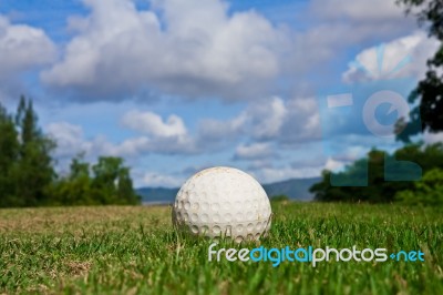 Golfball On Course And Blue Sky Stock Photo