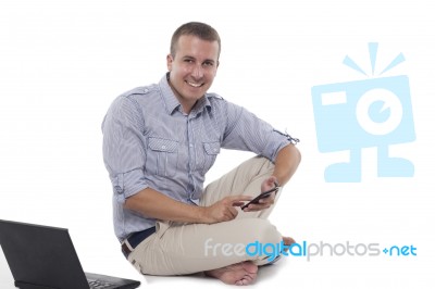 Good Looking  Man With Smart Phone  Seeting On Floo Stock Photo