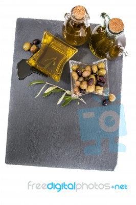 Green And Black Olives With Olive Oil Bottles Stock Photo