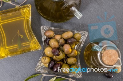 Green And Black Olives With Olive Oil Bottles Stock Photo