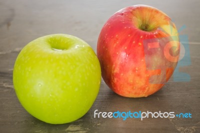Green And Red Apple On The Table Stock Photo