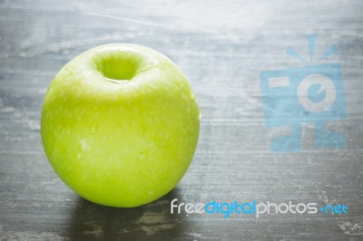 Green Apple On The Table Stock Photo
