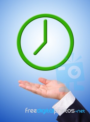 Green Clock On Hand Stock Photo
