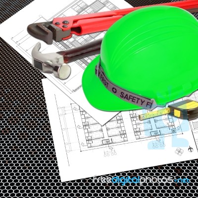 Green Helmet Of Safety Officer Constructor With Blueprints Stock Photo