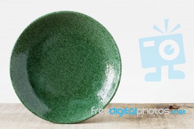 Green Plate On Wooden Stock Photo