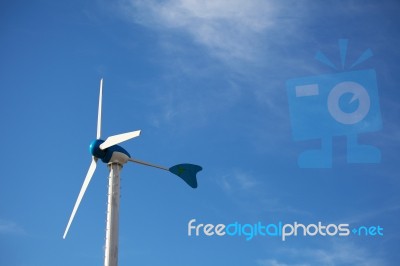 Green Renewable Energy Concept - Wind Generator Turbines On Blue… Stock Photo Green Renewable Energy Concept - Wind Generator Turbines On Blue… Stock Photo