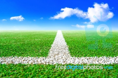 Green Soccer Field And Blue Sky Stock Photo