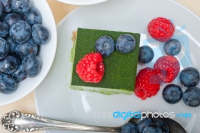 Green Tea Matcha Mousse Cake With Berries Stock Photo