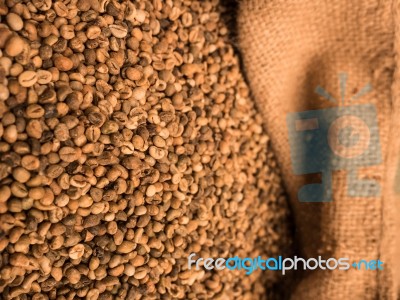 Green Unroasted Coffee Beans In Sack Stock Photo