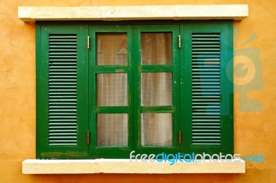 Green Window On Yellow Wall Stock Photo