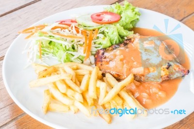 Grilled Chicken Steak With French Fries And Vegetables Stock Photo