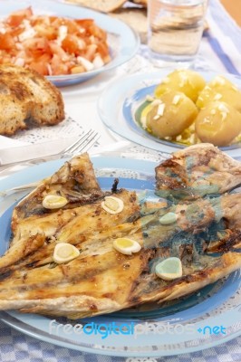 Grilled European Seabass With Potato And Tomato Salad Stock Photo