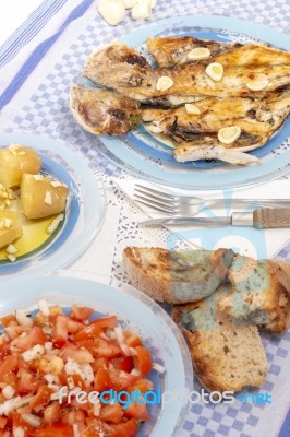 Grilled European Seabass With Potato And Tomato Salad Stock Photo