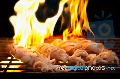 Grilled Fresh Squid On Flaming In Seafood Stock Photo