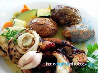 Grilled Octopus, Potatoes And Vegetables Stock Photo