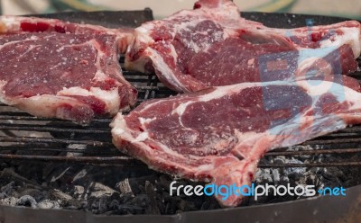 Grilling Steak On The Barbecue Stock Photo