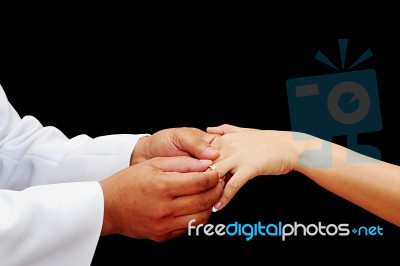 Groom Places Wedding Ring To Bride Stock Photo