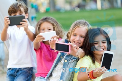 Group Of Childrens Taking A Selfie In The Park Stock Photo