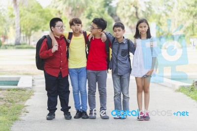 Group Of Kids Friends Arm Around Standing Having Fun And Smiling In Park Stock Photo