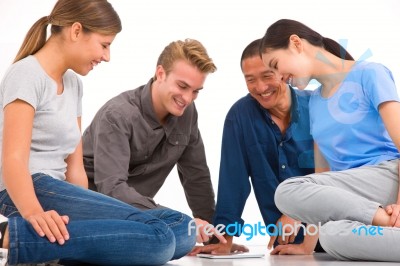 Group Of Multi-ethnic Friends Looking Digital Tablet Stock Photo