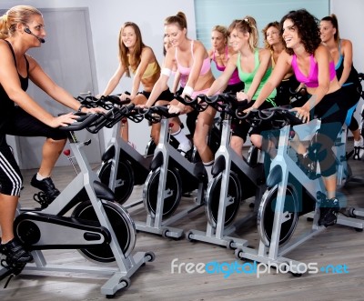 Group Of People Doing Exercise On A Bike Stock Photo