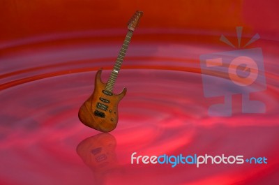Guitar On Red Water Stock Image