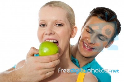Guy Feeding Green Apple To Lover Stock Photo