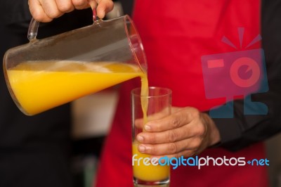 Guy Pouring Fresh Juice In Glass Stock Photo