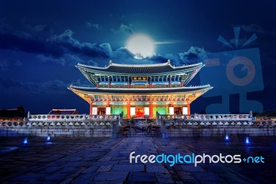 Gyeongbokgung Palace And Full Moon At Night In Seoul, South Korea Stock Photo