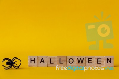 Halloween Wooden Blocks With Spiders On Yellow Background, Stock Photo