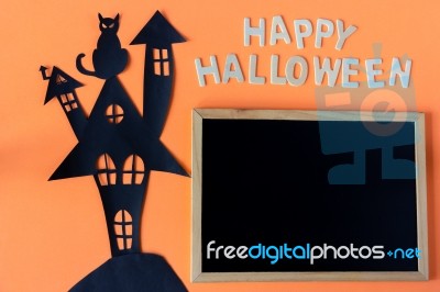 Halloween Word With Chalkboard And Haunted House Castle And Black Cat  On Orang Stock Photo