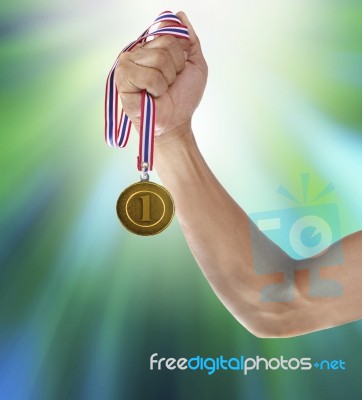 Hand And Gold Medal Stock Photo
